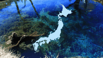 日本列島の形のシルエットと、底の水草まで透き通った忍野八海・湧池の青い水面